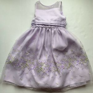 A purple dress with green and purple flowers